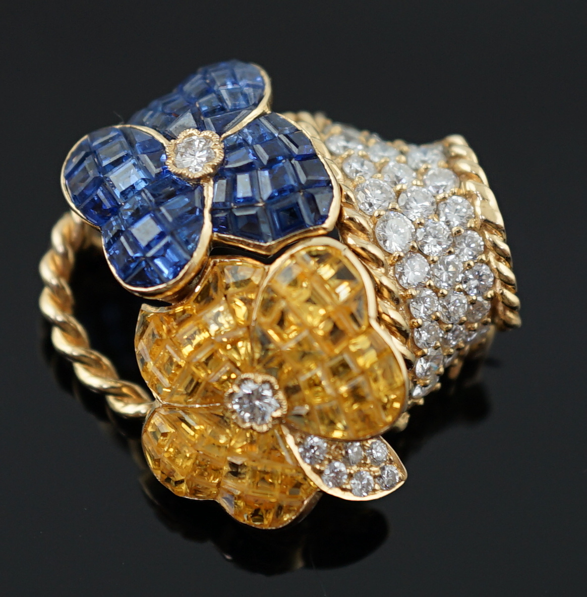 A Tiffany & Co 18k gold, two colour sapphire and diamond cluster set brooch, modelled as a basket with two flower heads
